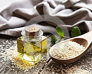 Sesame oil and seeds on a rustic table