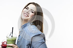 Healthy Food Eating. Happy Caucasian Woman Drinking With Both Green and Red Detox Vegetable Smoothie. Posing in Striped Blue-White