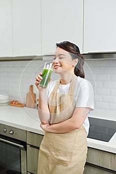 Healthy Food And Eating. Happy Young Woman Drinking Green Detox Vegetable Smoothie