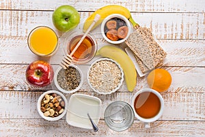 Healthy Food Fiber Source Breakfast Oatmeal Honey Fruits Apples Banana Orange Juice Water Green Tea Nuts. White Plank Wood Table