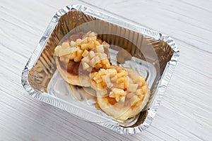 Healthy food in foil box, diet concept. Apple dessert