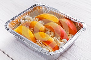 Healthy food in foil box, diet concept. Apple dessert