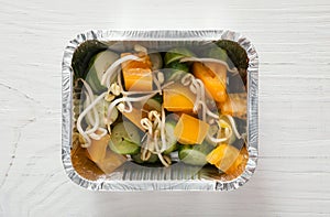 Healthy food in foil boxes, diet concept. Soy sprouts salad