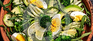 Healthy food. Fresh green salad on black background, Long banner format. Food recipe background. Close up