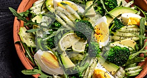 Healthy food. Fresh green salad on black background, Long banner format. Food recipe background. Close up