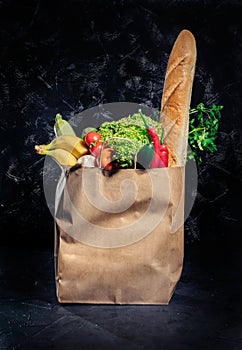 Healthy food in full paper bag of different products vegetables and fruits
