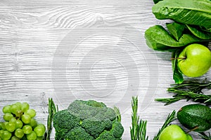 Healthy food with green vegetables, fruits for dinner on gray table background top view mock up