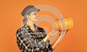Healthy food growing. retro woman hold pumpkin. girl with gourd. farmer harvesting in countryside. fall seasonal concept