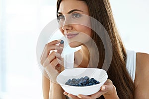 Healthy Food. Happy Woman On Diet Eating Organic Blueberries