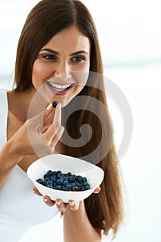 Healthy Food. Happy Woman On Diet Eating Organic Blueberries