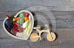 Healthy food in heart and bike diet sport lifestyle concept on vintage boards