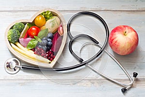 Healthy food in heart diet concept with stethoscope photo