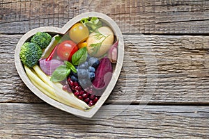 Healthy food in heart diet cooking concept with fresh fruits and vegetables