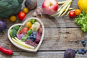 Healthy food in heart diet cooking concept with fresh fruits and vegetables