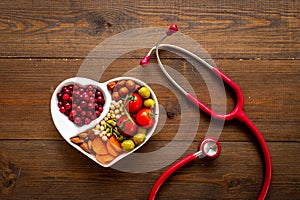 Healthy food in heart shaped plate with stethoscope. Healthy nutrition eating