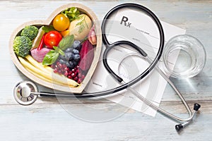 Healthy food in heart stethoscope and medical prescription diet and medicine concept photo