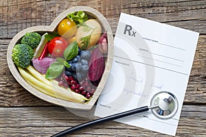 Healthy food in heart stethoscope and medical prescription diet and medicine concept