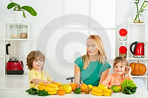 Healthy food at home. Portrait of cute family is making fruit juice. on white kitchen. Raw, vegan, vegetarian, alkaline