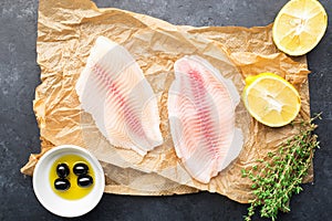 Healthy food ingredients. Fresh sea fish fillet, lemons, spices, salt, herbs, spices for a comfortable diet. Against a