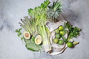 Healthy food ingredients gree vegetables and fruits on gray background