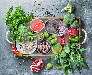 Healthy food ingredients in wooden box over grey background