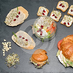 Healthy food, menu with microgreens. Vegetarian sandwiches with micro greens assortment. Vegan party food table with