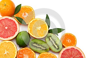 healthy food. mix sliced lemon, green lime, orange, mandarin, kiwi fruit and grapefruit with green leaf isolated on white