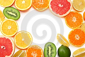 healthy food. mix sliced lemon, green lime, orange, mandarin, kiwi fruit and grapefruit with green leaf on white