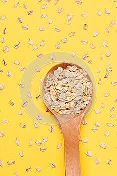 Healthy food. Muesli for breakfast. Wooden spoon. Yellow background