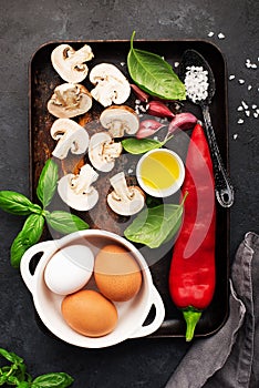 Healthy food nutrition. Ingredients for vegetable wholesome frittata: capsicum pepper, mushrooms, basil, garlic, organic