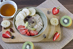 Healthy food,oatmeal breakfast and fruit on wooden background top view close up.