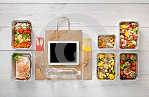 Healthy food online order in boxes, top view at wood