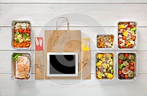 Healthy food online order in boxes, top view at wood