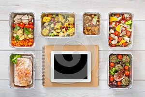 Healthy food online order in boxes, top view at wood