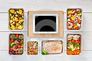 Healthy food online order in boxes, top view at wood