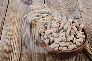 Healthy food products. Extruded rye bran on white background