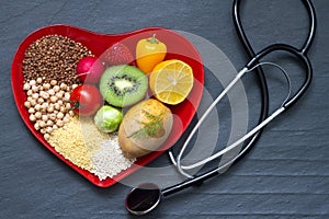 Healthy food on red heart plate