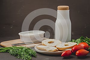 Healthy food with round toast, bottle, vegetables and cheese/Healthy food with round toast, bottle, vegetables and cheese on black