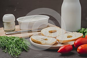 Healthy food with round toast, bottle, vegetables and cheese/Healthy food with round toast, bottle, vegetables and cheese on black