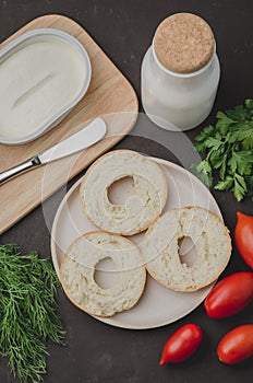 Healthy food with round toast, bottle, vegetables and cheese/Healthy food with round toast, bottle, vegetables and cheese on black