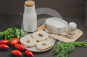 Healthy food with round toast, bottle, vegetables and cheese/Healthy food with round toast, bottle, vegetables and cheese on black