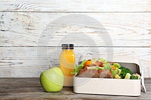 Healthy food for school child in lunch box on table