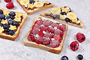 Healthy food with slice of spelt toast bread topped with red raspberry and puffed quinoa grains