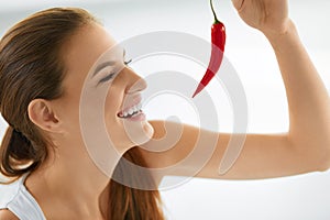 Healthy Food. Smiling Woman Holding Red Chili Pepper. Lifestyle