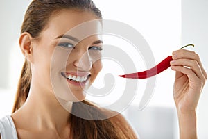 Healthy Food. Smiling Woman Holding Red Chili Pepper. Lifestyle