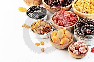 Healthy food snacks: natural dried fruits mix in bowls on white background