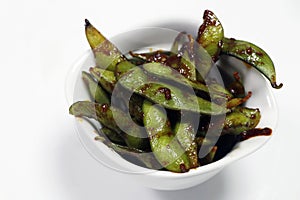 healthy food steamed and spiced soybeans known as edamame with white background