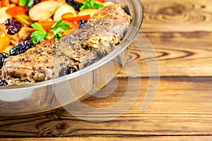 Healthy food, stewed pork meat with various colorful vegetables in pan on wooden background, selective focus