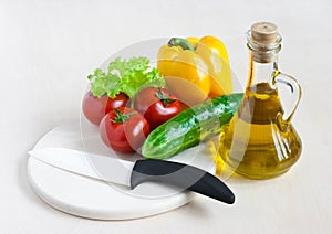 Healthy food still life with white ceramic knife