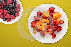 Healthy food. Strawberries and apricots on a white plate. fresh fruits on a background top view
